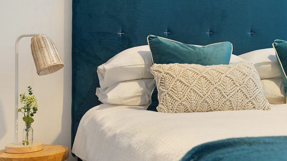 blue bed and mattress with pillows