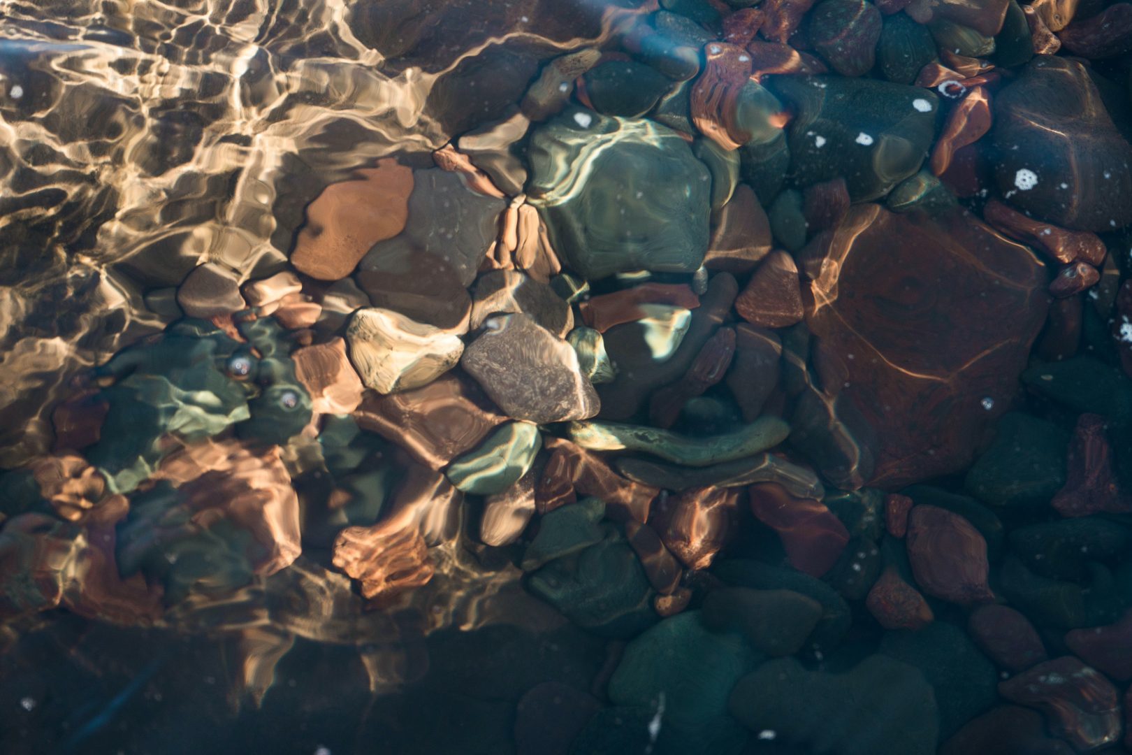 brown and gray stone on water