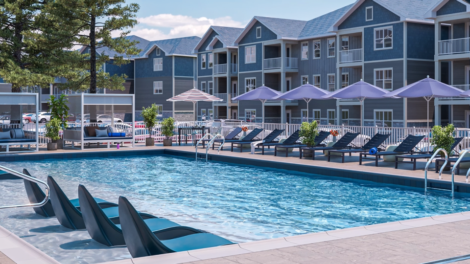 a pool with lounge chairs and umbrellas in front of a resort at The  Preserve at Sycamore Creek