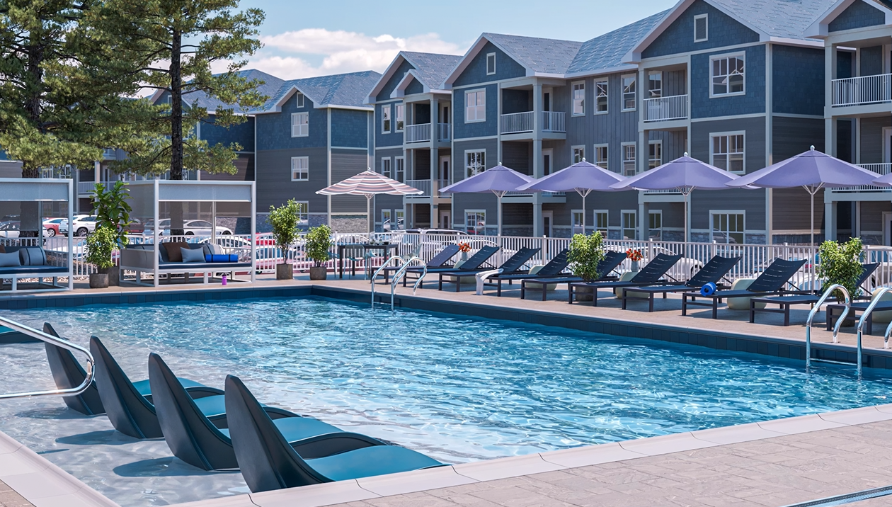 a pool with lounge chairs and umbrellas in front of a resort at The  Preserve at Sycamore Creek